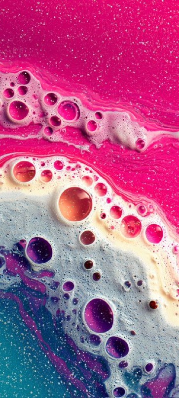 Empty modern office lobby with large windows, reception desk, white walls, and gray carpet.